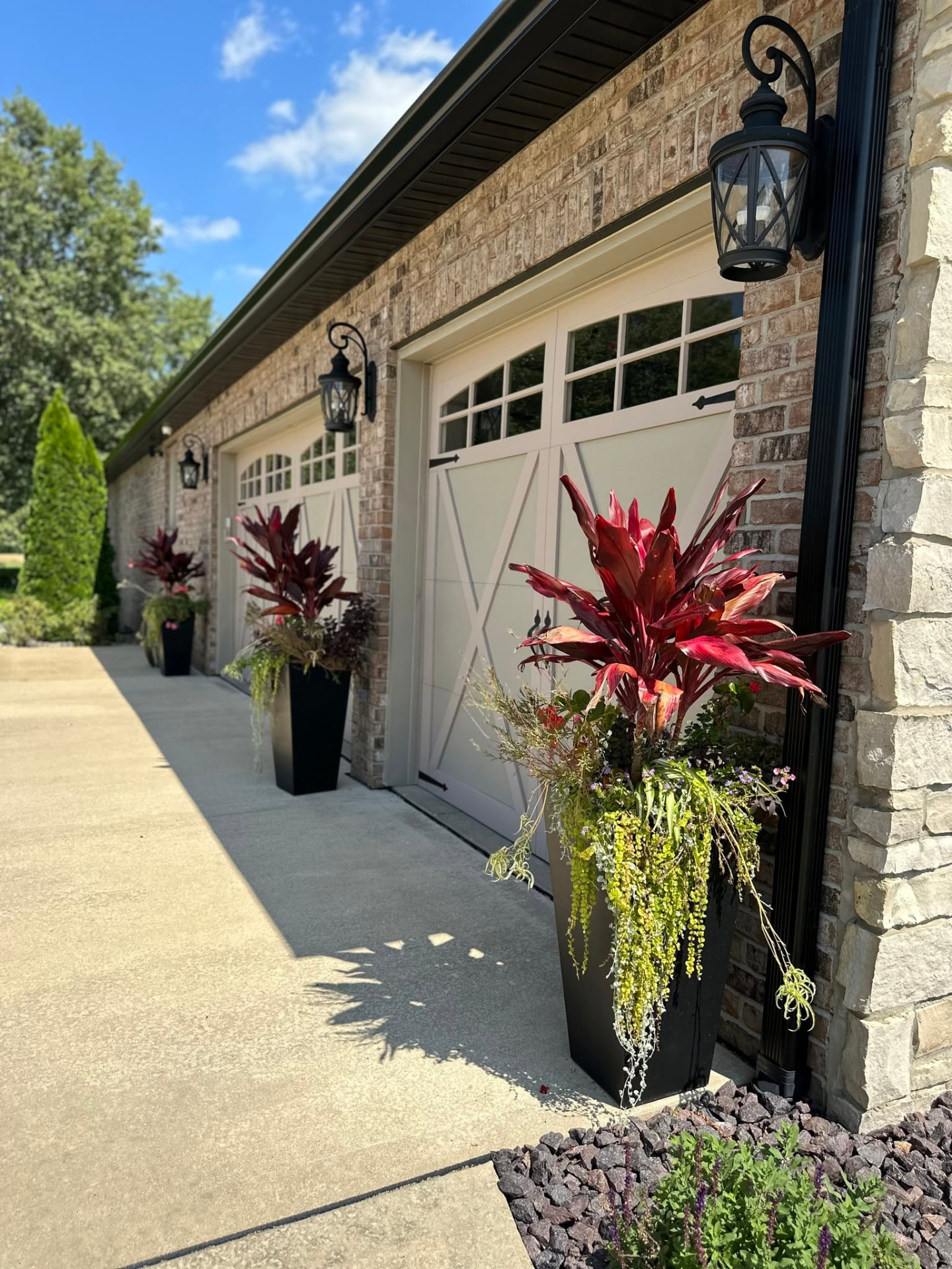 Decorative container plants along garage entry