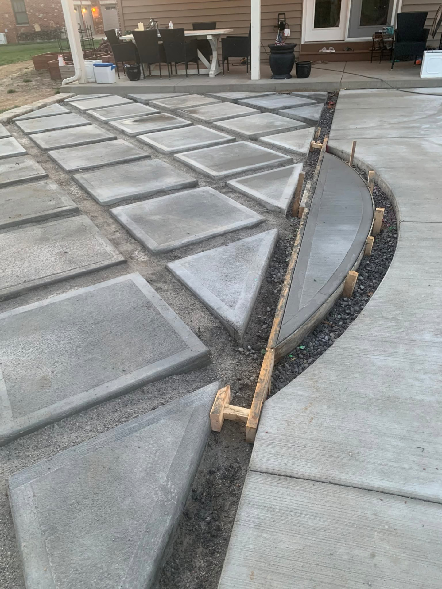 Concrete paver sections being formed and set during installation